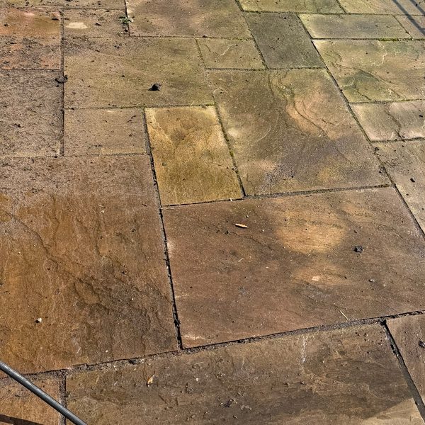 Indian sandstone patio in Uttoxeter before cleaning